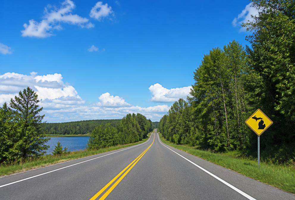 An open Michigan two-lane highway with a Michigan-shaped road sign
