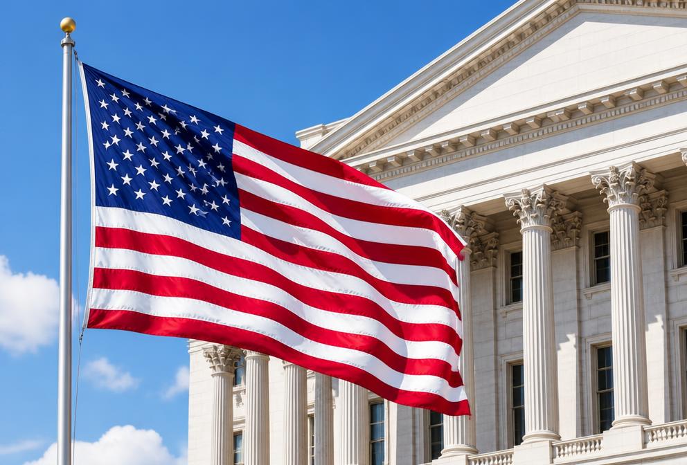 An American flag flying in front of a columned federal building